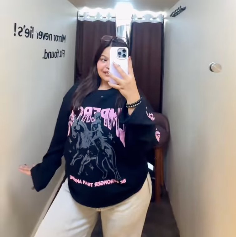 Black graphic sweatshirt with cream trousers, styled at D’ Closet