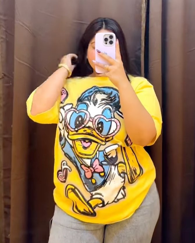 Oversized yellow cartoon graphic tee at D’ Closet Bulandshahr
