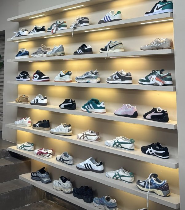 Backlit sneaker wall at D’ Closet footwear store in Bulandshahr